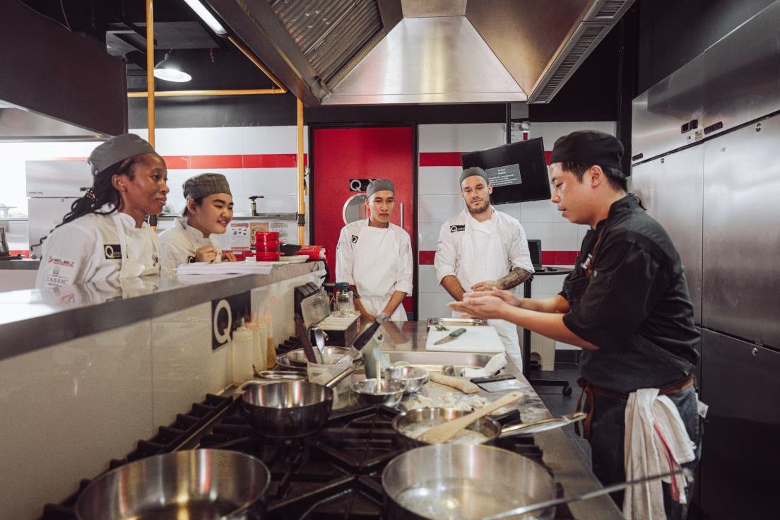 Head Instructor Nick Tran and Students at the practical training class at Q.uriosity Culinary Academy Vietnam. Photo: QCA